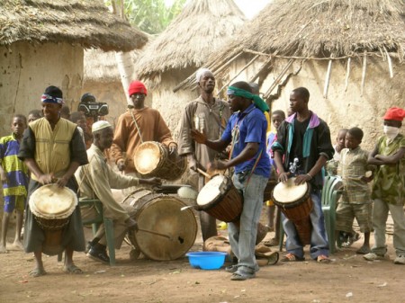 Famoudou Konate and Seckou Conde playing in a djembe ensemble